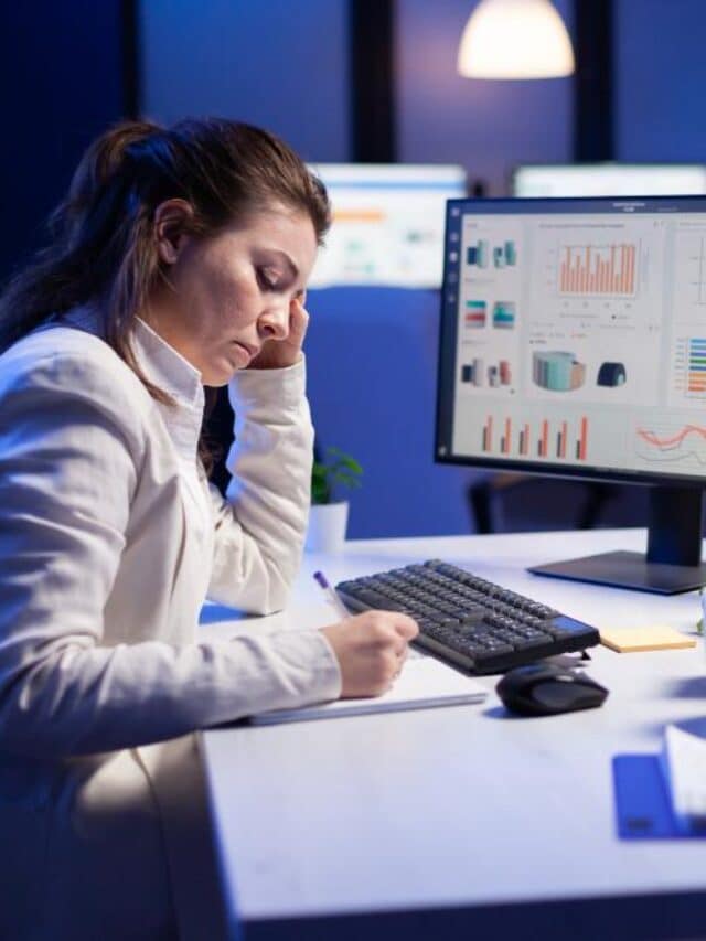 back-shot-overwhelmed-woman-working-night-front-computer-writing-notes-notebook-annual-reports-checking-financial-deadline